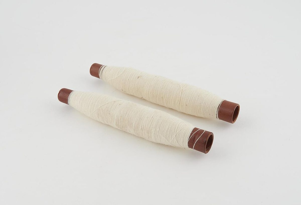 Bobbins of spun yarn from a spinning machine