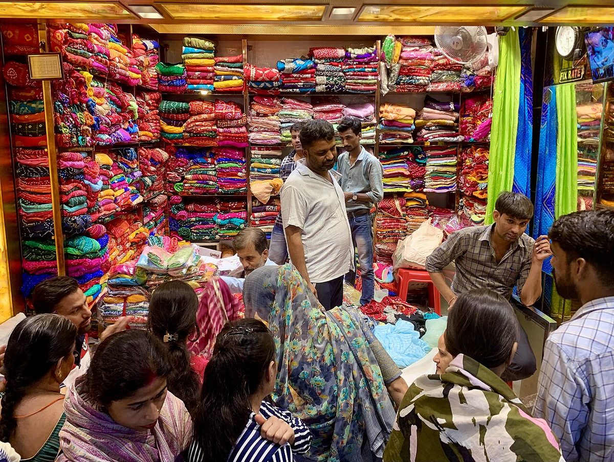 A busy fabric shop with shelves of rolled cloth
